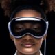 A strong black woman wears apple's vision pro goggles